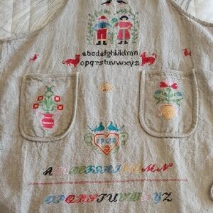Whimsical Embroidered Apron with Alphabet and Floral Motifs